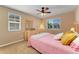 Cozy bedroom with a ceiling fan, two windows, and a light wood dresser at 13794 E Caley Dr, Englewood, CO 80111