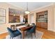 Dining room with hardwood floors, view of the bar, and eat in kitchen area at 13794 E Caley Dr, Englewood, CO 80111