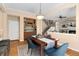 Open-concept dining area with a view of the living room, bar area, and hardwood floors at 13794 E Caley Dr, Englewood, CO 80111