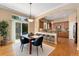 Inviting dining area with hardwood floors, adjacent to an open kitchen and sliding doors to the backyard at 13794 E Caley Dr, Englewood, CO 80111