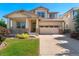 Charming two-story home with landscaped front yard, covered porch, and attached two-car garage at 13794 E Caley Dr, Englewood, CO 80111