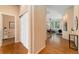 Inviting hallway with hardwood floors leading to a bright living space, showcasing an open and airy design at 13794 E Caley Dr, Englewood, CO 80111