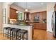 Kitchen featuring granite countertops, a breakfast bar, and stainless-steel appliances at 13794 E Caley Dr, Englewood, CO 80111