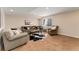 Basement living room with sofa, chair, and an animal print rug at 13794 E Caley Dr, Englewood, CO 80111