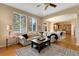 Bright living room with hardwood floors, large windows, and view to the kitchen at 13794 E Caley Dr, Englewood, CO 80111