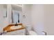 Bright powder room featuring a vanity with bronze fixtures and neutral-toned countertop at 1180 S Troy St, Aurora, CO 80012