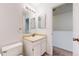 A neutral colored bathroom featuring a large mirror and modern fixtures at 1180 S Troy St, Aurora, CO 80012