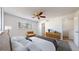 The primary bedroom features a ceiling fan and a brown leather chair at 1180 S Troy St, Aurora, CO 80012