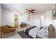 Bright bedroom with a ceiling fan, comfortable bed, chair, and modern decor at 1180 S Troy St, Aurora, CO 80012