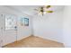 Well-lit empty room with wood floors, a window, and a door perfect for an office or dining area at 1180 S Troy St, Aurora, CO 80012