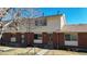 Attractive brick townhome with well-maintained landscaping and decorative front door at 1180 S Troy St, Aurora, CO 80012