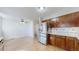 Spacious kitchen featuring stainless steel appliances, warm cabinetry, and adjoining dining area at 1180 S Troy St, Aurora, CO 80012