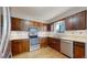 Efficient kitchen featuring stainless steel appliances, ample counter space, and warm-toned cabinetry at 1180 S Troy St, Aurora, CO 80012