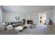 Inviting living room with a cozy fireplace, neutral-toned furniture, and ample natural light at 1180 S Troy St, Aurora, CO 80012