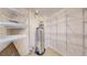 Functional storage area with a water heater and ample wire shelving at 1180 S Troy St, Aurora, CO 80012