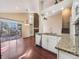 Open-concept living room flows into the kitchen featuring a fireplace and access to the deck at 9696 Pinebrook St, Highlands Ranch, CO 80130