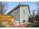 Back exterior features wood siding, mature trees, and stairs to deck at 9630 W La Salle Ave, Lakewood, CO 80227