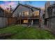 Well-maintained backyard with a spacious deck, lush green grass, and privacy fence at 9630 W La Salle Ave, Lakewood, CO 80227