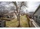 Large backyard features a wood fence, mature trees, wood deck, and well-maintained grass at 9630 W La Salle Ave, Lakewood, CO 80227