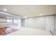 Finished basement area with laminate flooring, neutral carpeting, a window, and fresh paint at 9630 W La Salle Ave, Lakewood, CO 80227