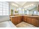 Bathroom features a double sink vanity and soaking tub with shower at 9630 W La Salle Ave, Lakewood, CO 80227