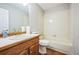 Bathroom featuring a vanity, toilet and tub with tile surround at 9630 W La Salle Ave, Lakewood, CO 80227