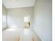 A spacious bedroom with neutral carpet and an attached bathroom with a tub and natural light at 9630 W La Salle Ave, Lakewood, CO 80227
