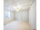 Bright bedroom features neutral carpet, a ceiling fan, and a window for natural light at 9630 W La Salle Ave, Lakewood, CO 80227