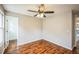 Neutral bedroom features natural light from the window and ceiling fan at 9630 W La Salle Ave, Lakewood, CO 80227