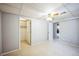 This bedroom has neutral carpet, an open closet, and a view of another room at 9630 W La Salle Ave, Lakewood, CO 80227
