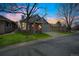 Charming home featuring mature trees, brick accents, a two-car garage and well-maintained lawn at 9630 W La Salle Ave, Lakewood, CO 80227