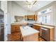 Bright kitchen features wood cabinets, an island, stainless appliances and hardwood floors at 9630 W La Salle Ave, Lakewood, CO 80227