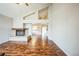 Bright living room featuring soaring ceilings, a cozy fireplace, and wood floors at 9630 W La Salle Ave, Lakewood, CO 80227