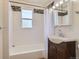 Updated bathroom featuring a combination tub and shower, modern vanity, and stylish finishes at 1390 Estes St, Lakewood, CO 80215