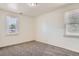 Bright bedroom with neutral carpet, white walls, and two windows providing plenty of natural light at 1390 Estes St, Lakewood, CO 80215