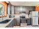 Well-appointed kitchen with stainless steel appliances, subway tile backsplash, and ample cabinetry at 1390 Estes St, Lakewood, CO 80215
