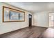Bright living room features dark wood floors, large bay window, and neutral paint at 1390 Estes St, Lakewood, CO 80215