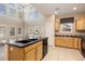 Modern kitchen with island, stainless steel appliances, and wood cabinets at 5596 W 72Nd Dr, Arvada, CO 80003