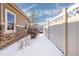 Side yard with snow and privacy fence at 5596 W 72Nd Dr, Arvada, CO 80003