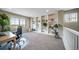 Bright bonus room featuring custom built-in shelving, perfect for a home office or library at 7301 S Mobile St, Aurora, CO 80016