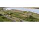 Aerial view of lake with parking, boat launch, roadways and green space at 7720 Brown Bear Way, Littleton, CO 80125
