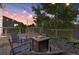 Outdoor deck with a fire pit surrounded by seating and string lights, perfect for evening relaxation and entertaining at 7720 Brown Bear Way, Littleton, CO 80125