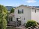 Charming two-story home featuring a private backyard, wood deck, lush landscaping, and partial fencing at 7720 Brown Bear Way, Littleton, CO 80125