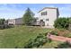 Spacious backyard with a swing set, lawn, and a well-maintained lawn at 7720 Brown Bear Way, Littleton, CO 80125