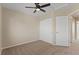 Bedroom with neutral paint and carpet, closet, and a ceiling fan at 7720 Brown Bear Way, Littleton, CO 80125