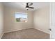 Cozy bedroom with neutral paint, carpet, and a large window offering lots of natural light at 7720 Brown Bear Way, Littleton, CO 80125