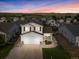 Charming two-story home featuring a well-maintained lawn and a two-car garage in a peaceful neighborhood setting at 7720 Brown Bear Way, Littleton, CO 80125