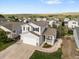 Charming two-story home featuring a covered porch, attached garage, and well-manicured landscaping at 7720 Brown Bear Way, Littleton, CO 80125