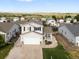 Charming two-story home featuring a covered porch, attached garage, and well-manicured landscaping at 7720 Brown Bear Way, Littleton, CO 80125