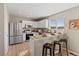 Stylish kitchen with white cabinets, stainless appliances, and a breakfast bar with stool seating at 7720 Brown Bear Way, Littleton, CO 80125